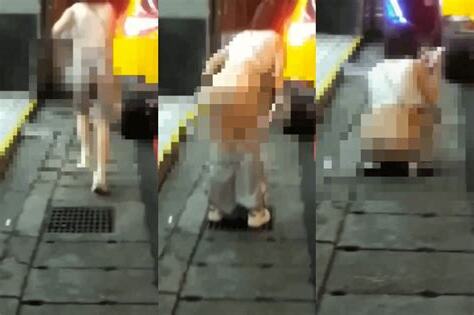 屁股慘被看光!年輕女路邊脱褲蹲水溝蓋 路人看傻眼